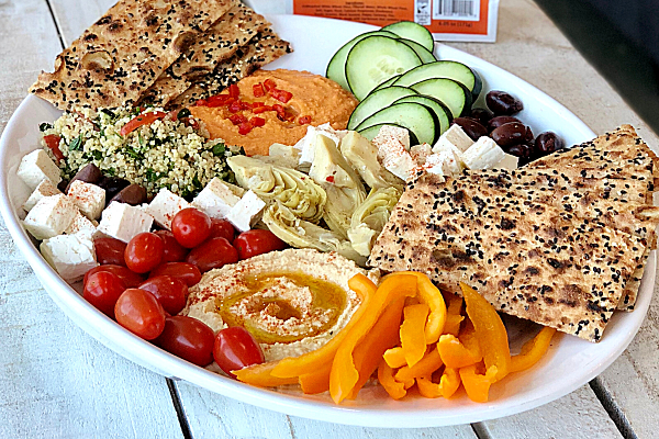 mezze-platter-sangak-crisps-hummus-tabbouleh-2 - BreadMasters Authentic Mediterranean mezze board with crispy Sangak flatbread, homemade hummus, fresh tabbouleh, cheese, olives, and garden vegetables for sharing